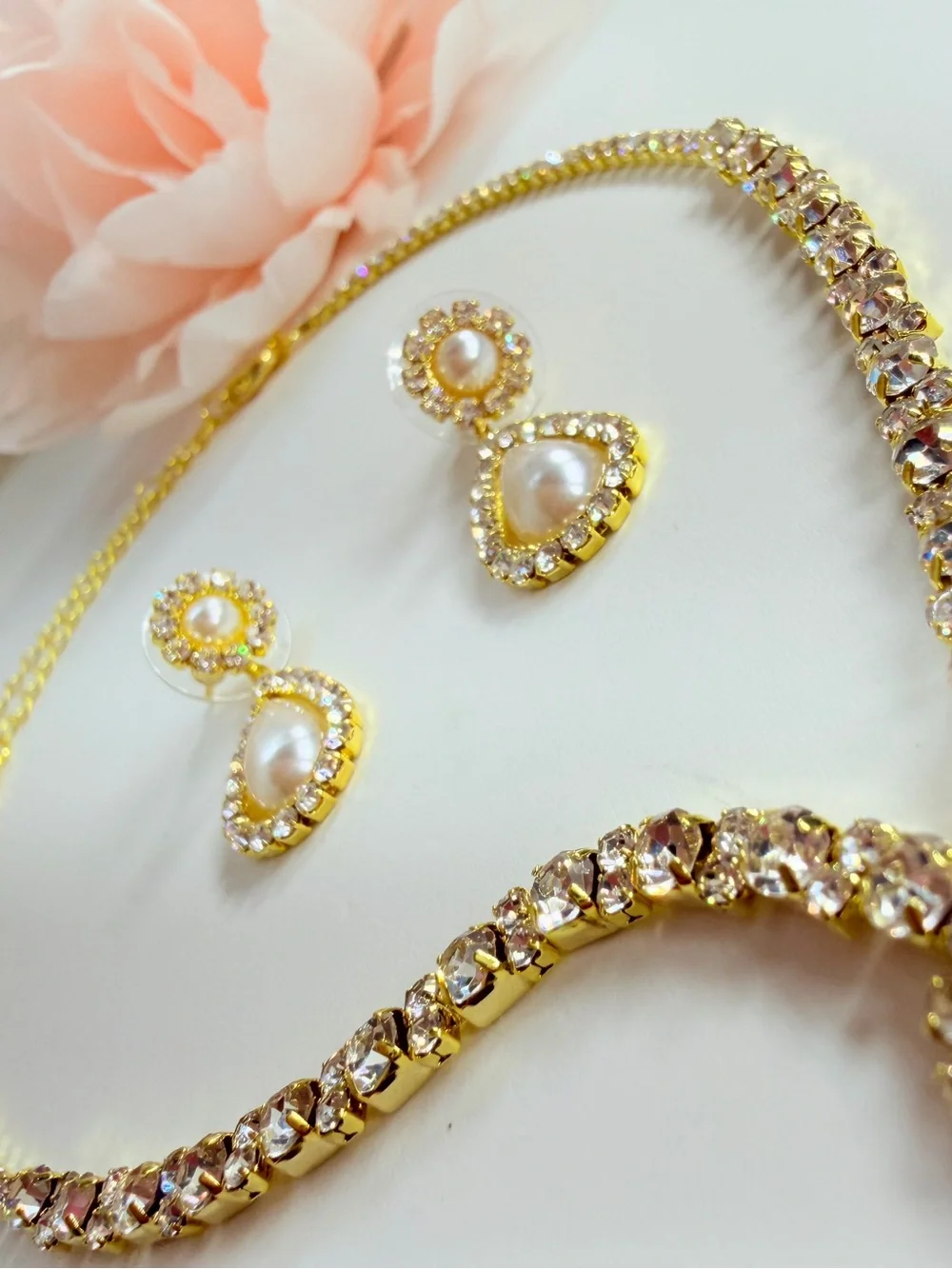 Elegant gold-tone necklace with earrings featuring a white teardrop pearl pendan